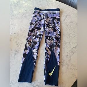 It is a purple and flower with black sand a neon green Nike symbols